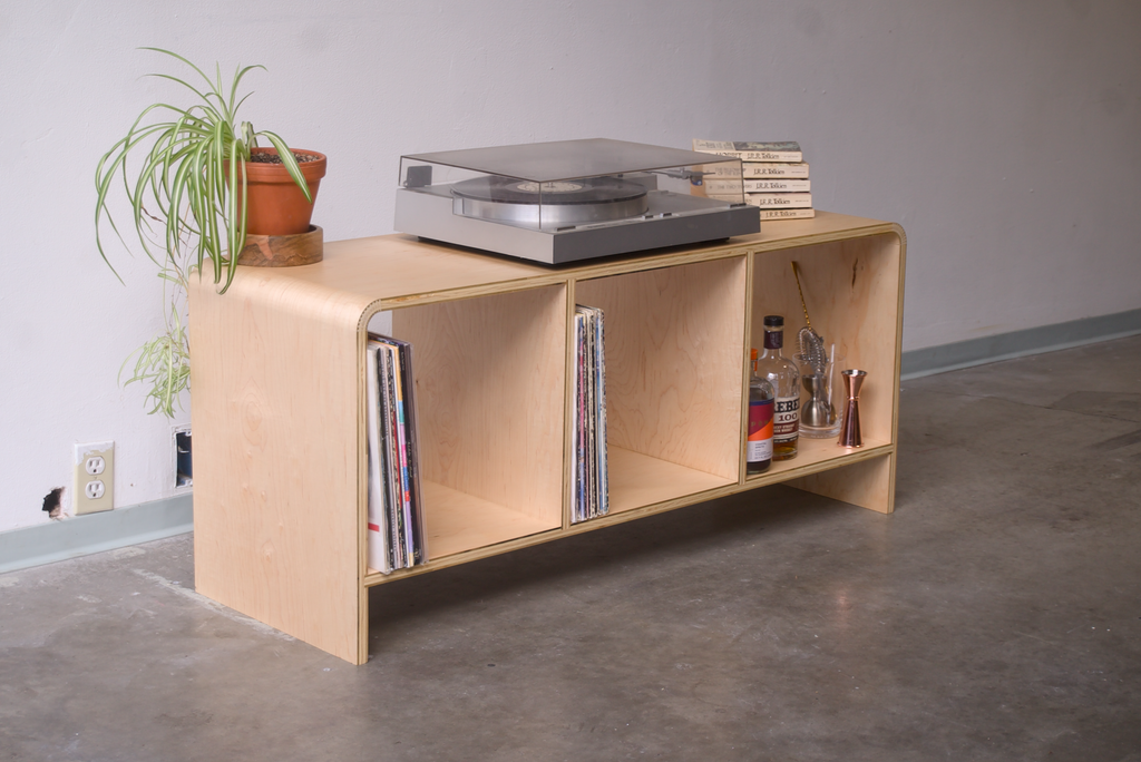 Maple Kerf Bent Record Console made out of plywood, to house vinyl storage, bottles, and books.
