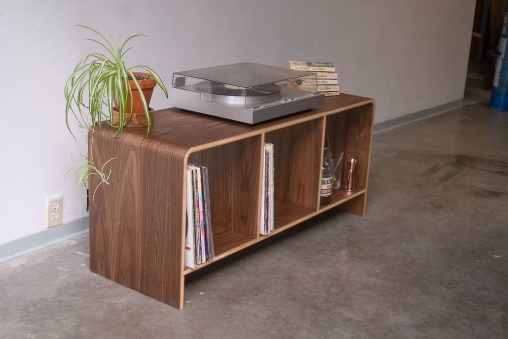Walnut Kerf Bent Record Console made out of plywood, to house vinyl storage, bottles, and books.